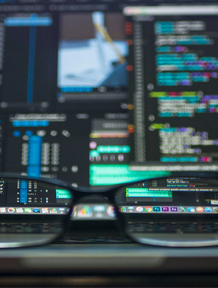 Engineer working across multiple monitors